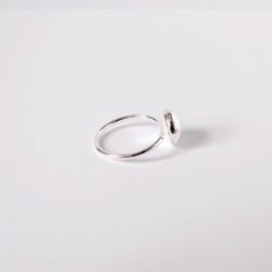 Round pebble silver ring on white background