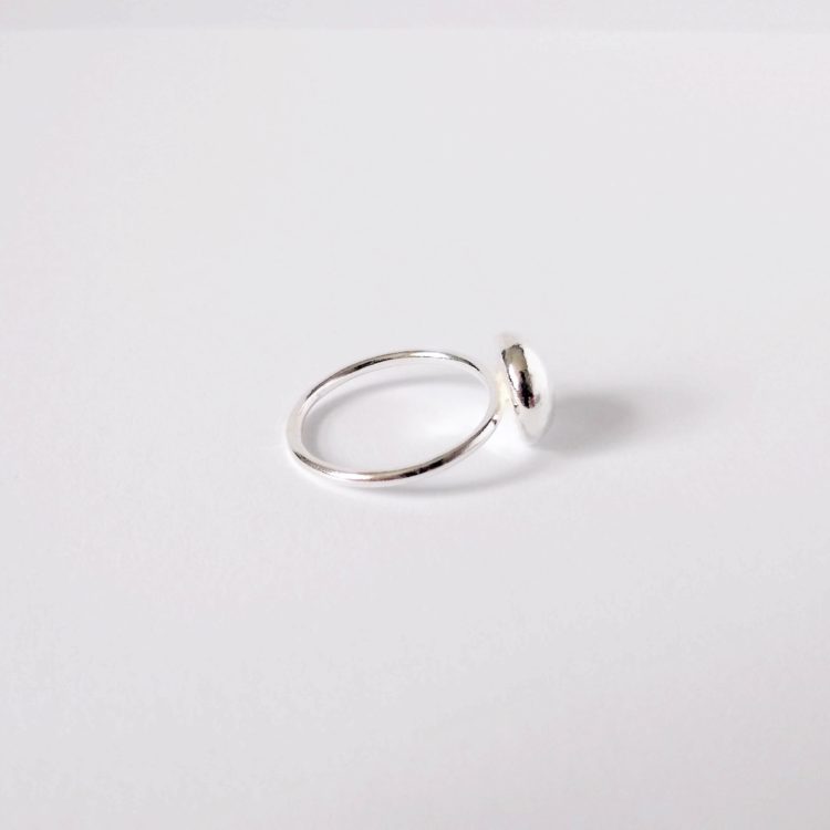 Round pebble silver ring on white background