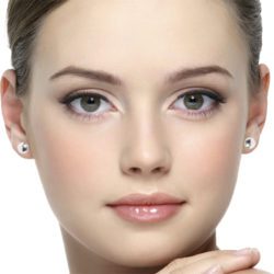 Model face wearing silver round pebble stud earrings