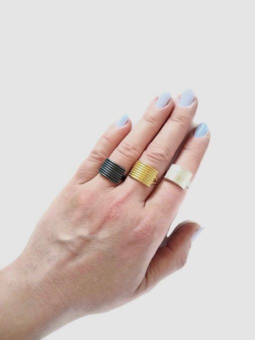 Stripes Ring collection by Essemgé - model wearing 3 rings, from left to right: oxidised silver 925, 18k yellow gold, shiny silver 925