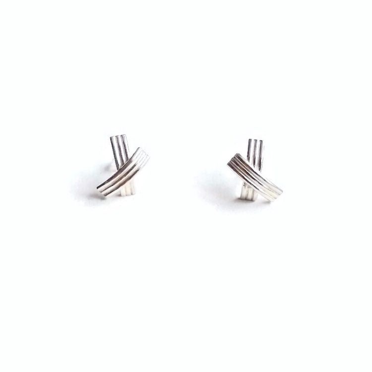 XX shiny silver stud earrings - standing upright against white background