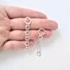 Nought-Chain-Dangle Earrings - shown on palm of hand for scale - on white background