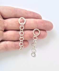 Nought-Chain-Dangle Earrings - shown on palm of hand for scale - on white background