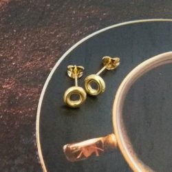 18k Yellow Gold Mini Torus Stud Earrings - on coffee saucer near coffee cup for scale