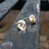 Gold & Silver Graphic Rose Stud Earrings - front view - on wet bench