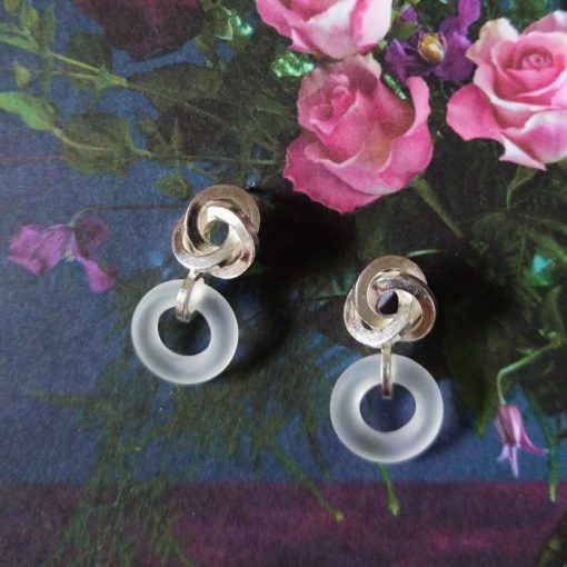 Graphic Rose Dangle Earrings - Silver and Frosted Rock Crystal - on floral background