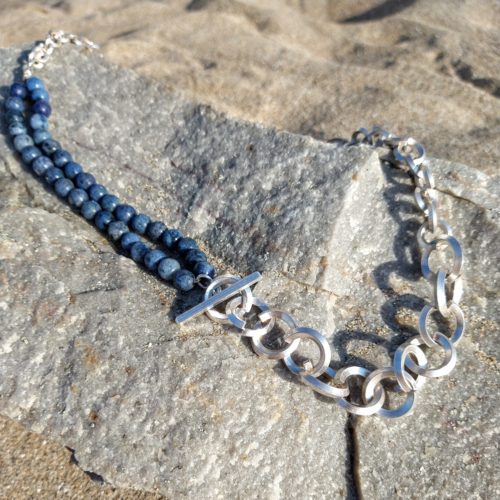 Bespoke Chain Necklace - jewellery commission designed and realised by Essemgé - silver and dumortierite gemstones - flat lay on natural rocks and sand background