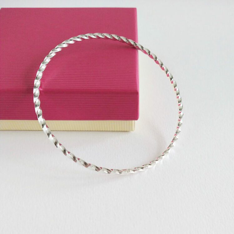 Twisted Square bangle by Essemgé - against gift box