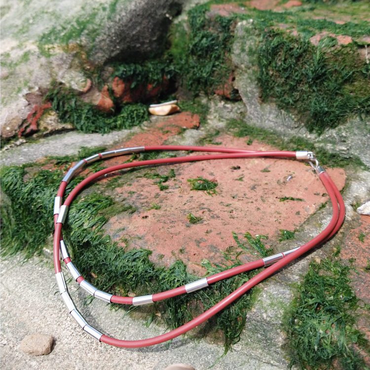 Silver Drape Multirow Necklace by Essemgé - burnt orange necklace on rock