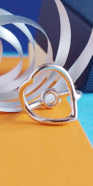 Heart Ring by Essemgé - silver ring on colourful background