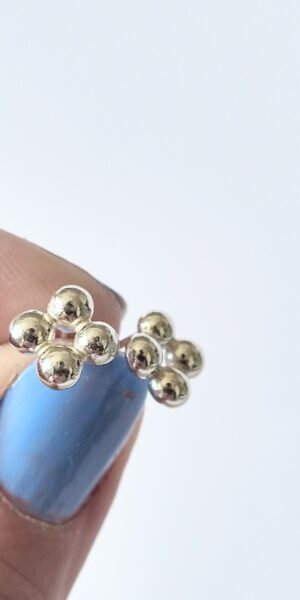 Quatrefoil Caviar silver studs by Essemgé - on hand for scale