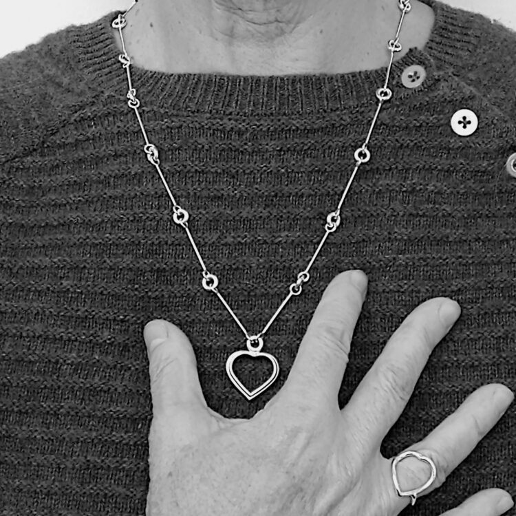 Heart Sautoir by Essemgé , together with the matching Heart Ring - long silver necklace and matching ring on model