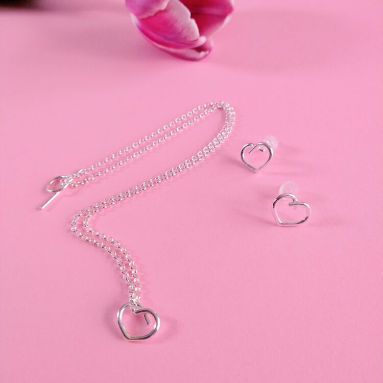 Mini Heart Necklace and Earrings set by Essemgé - silver pendant necklace and matching stud earrings on pink background