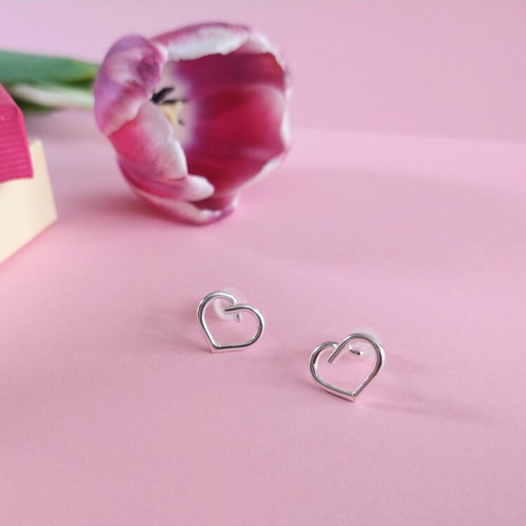 Mini Silver Heart Studs by Essemgé - silver stud earrings in heart shape , on pink background