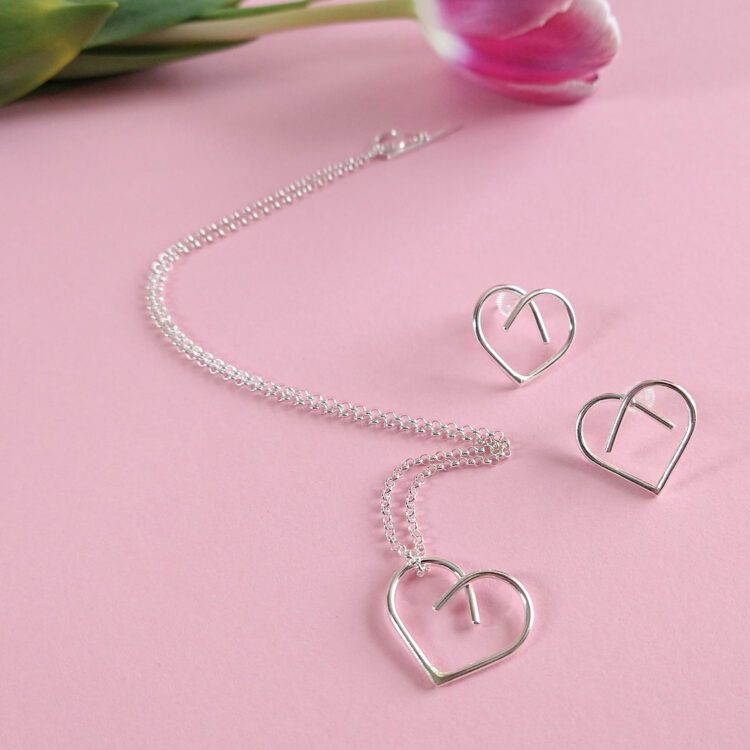 Midi Heart Pendant Necklace and Earrings set by Essemgé - silver pendant necklace and matching stud earrings on pink background