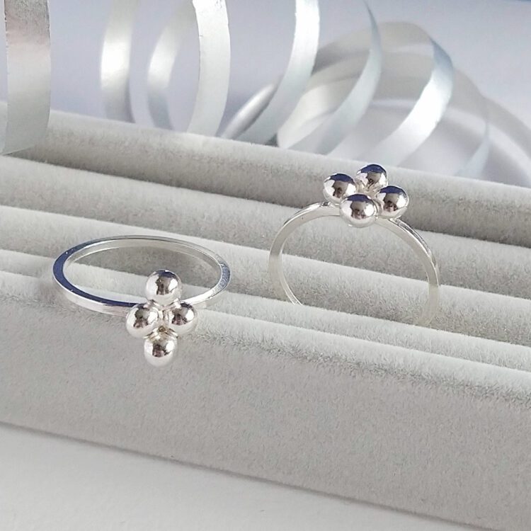 Quatrefoil Caviar Rings Set by Essemgé - 2 stacking silver rings on a grey background