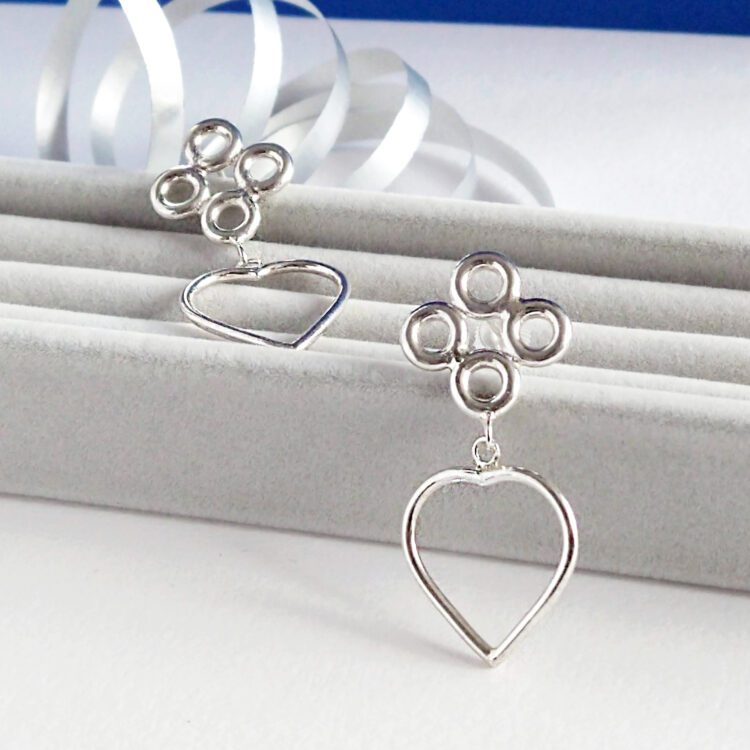 Quatrefoil Heart Dangle Earrings by Essemgé - silver earrings on grey and blue background