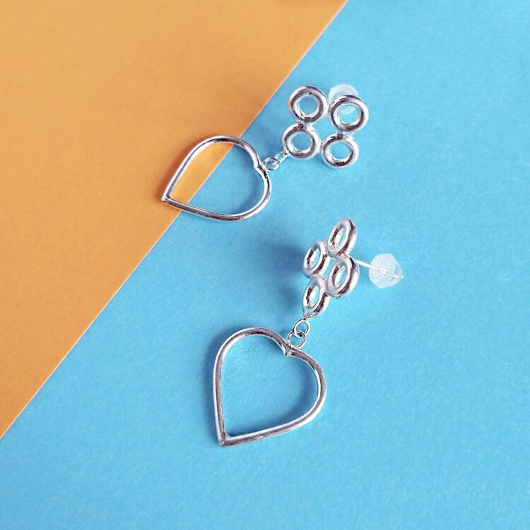 Quatrefoil Heart Dangle Earrings by Essemgé - silver earrings on colourful background