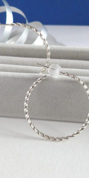Twisted Square Hoop Earrings by Essemgé - silver hoop earrings on grey background