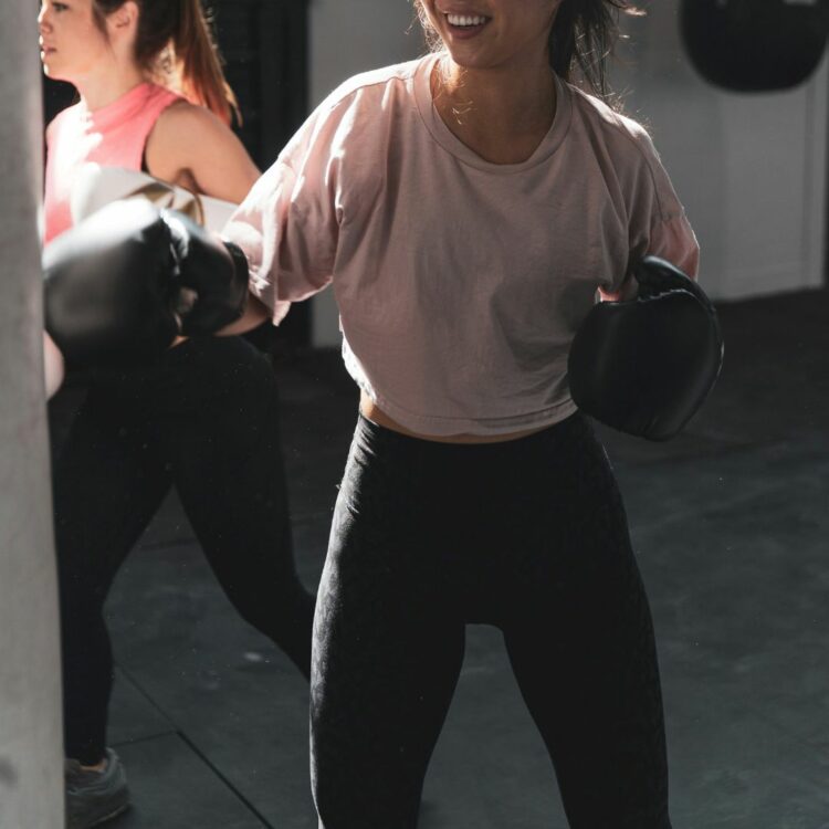 Jewellery and working out - A woman boxing at the gym
